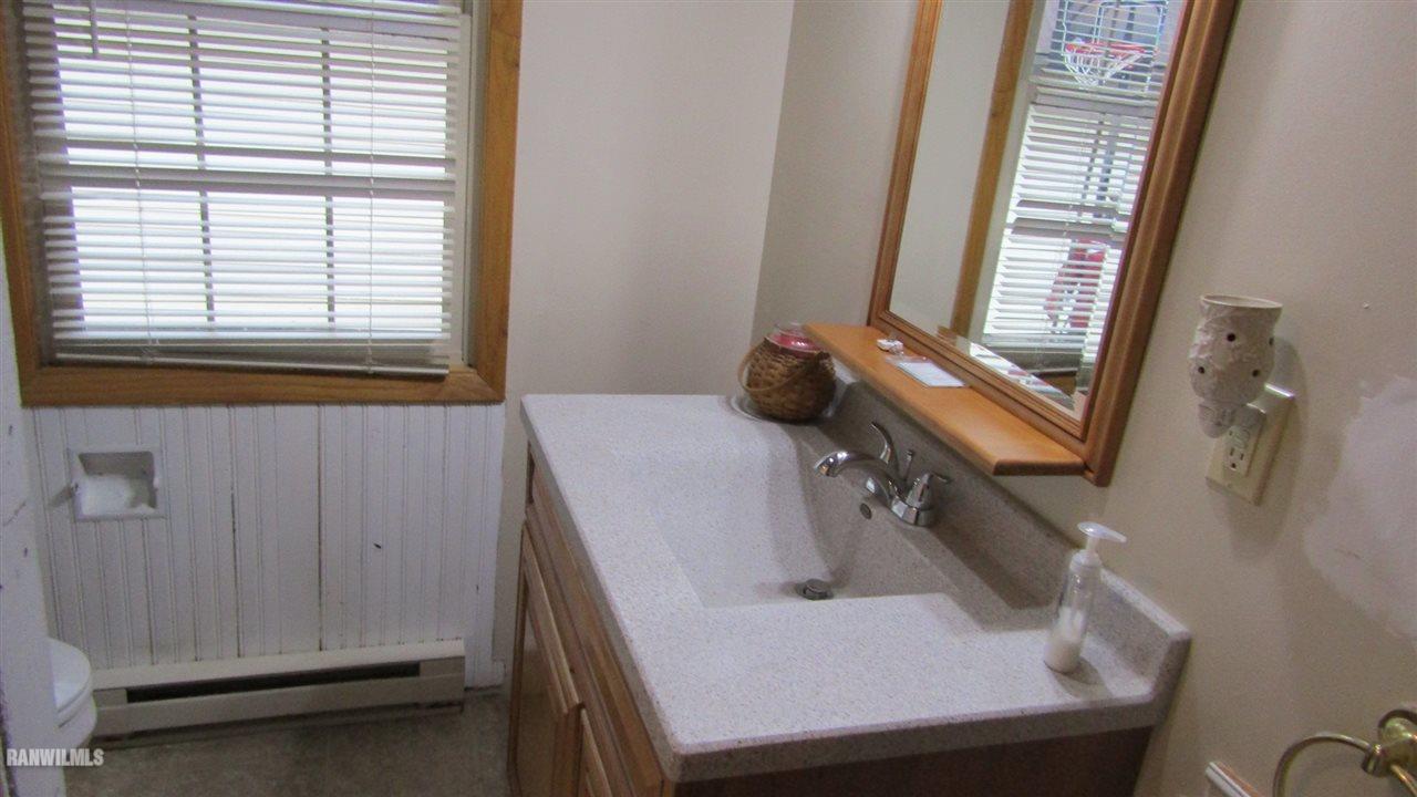11693 Maple Grove Road Lanark, IL 61046 - Photo 5 of 19 a bathroom with a sink and mirror with window