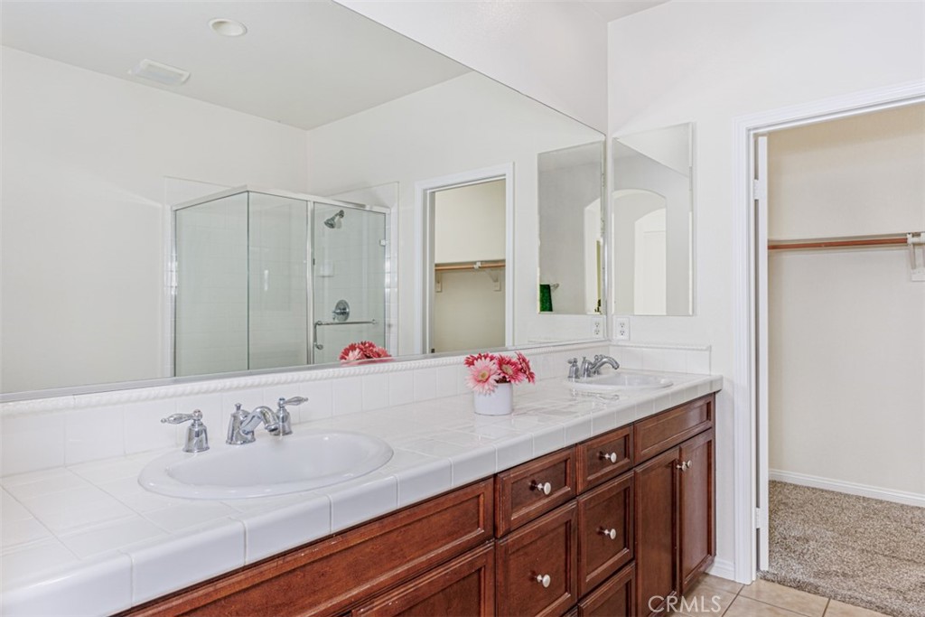 1401 Juliette Way Tustin, CA 92782 - Photo 15 of 27 a bathroom with a sink and a mirror