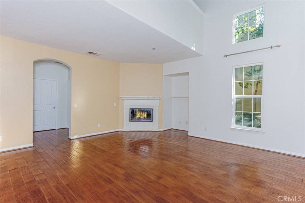 1401 Juliette Way Tustin, CA 92782 - Photo 3 of 27 an empty room with windows and a fireplace