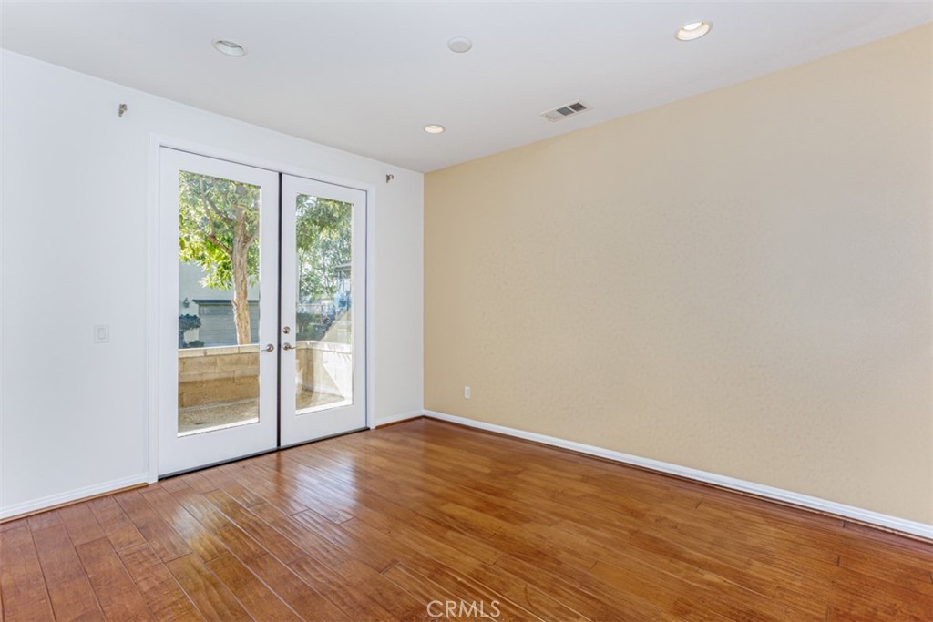 1401 Juliette Way Tustin, CA 92782 - Photo 4 of 27 a view of an empty room with wooden floor and a window