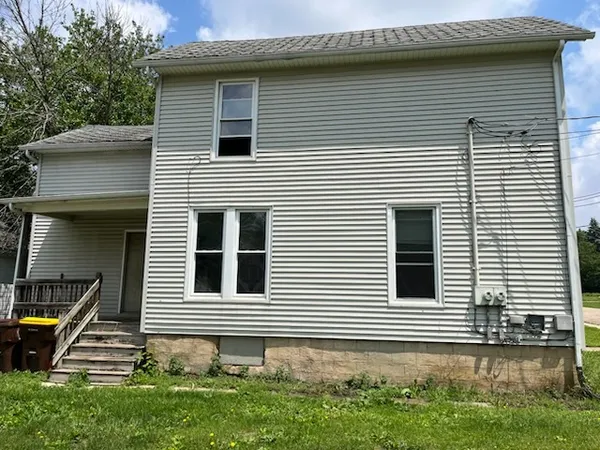 a side view of a house with a yard and a garage
