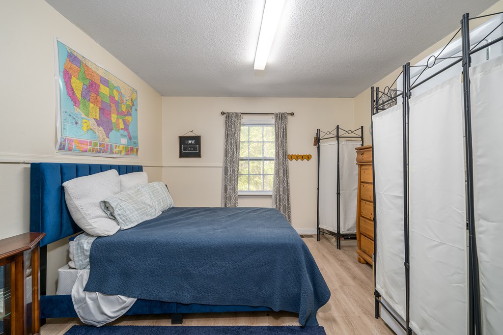 1813 John Smith Road East Blairsville, GA 30512 - Photo 6 of 41 a bedroom with a bed and wooden floor