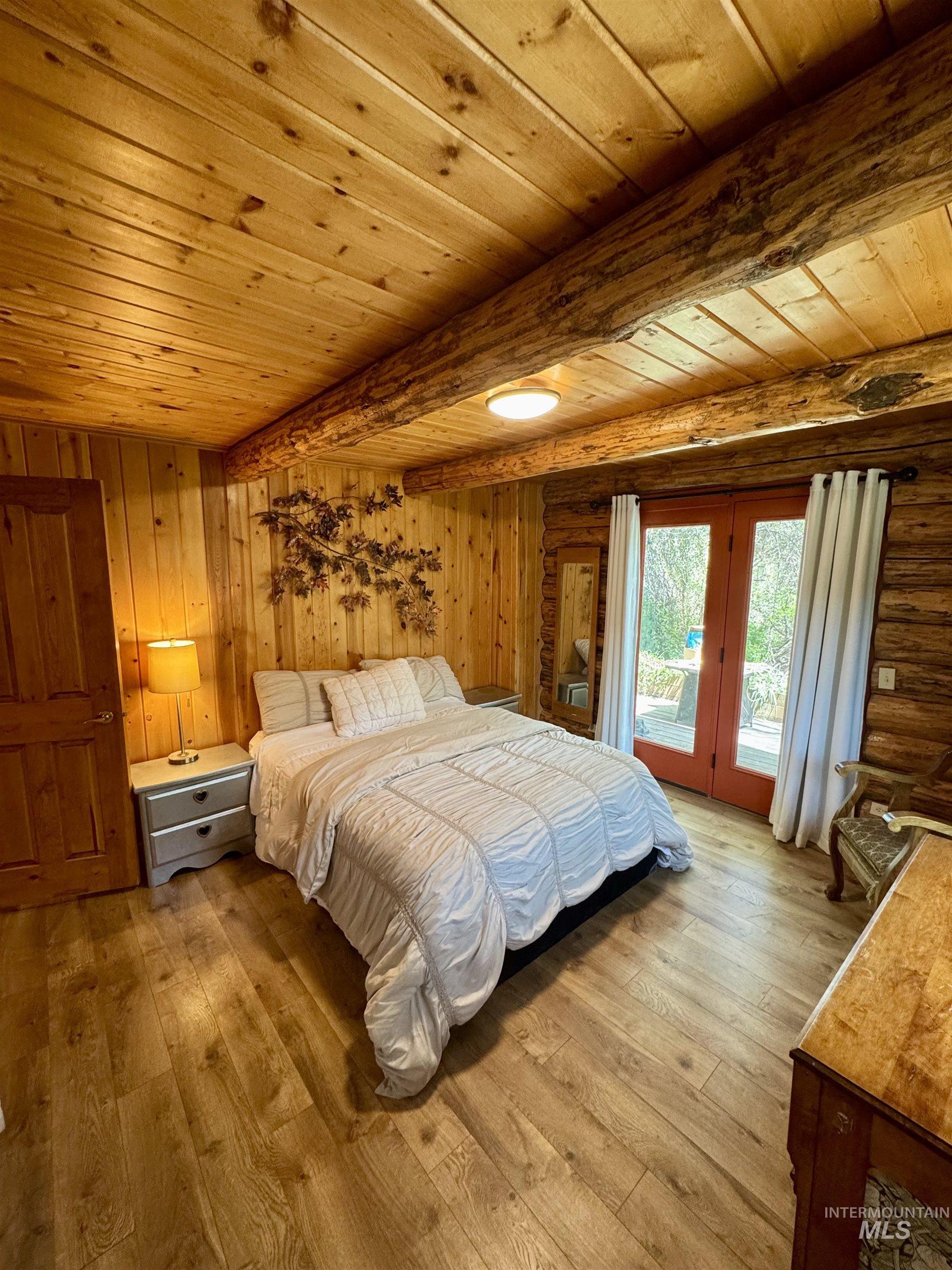 62 Bell Rapids Road Hagerman, ID 83332 - Photo 16 of 34 Wood-paneled room with exposed wood beams and wood-finish flooring
