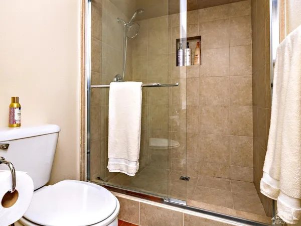 a bathroom with a toilet and a shower