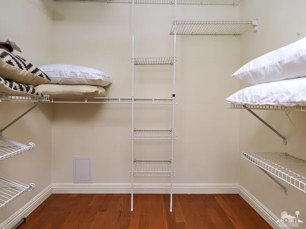 a view of walk in closet with empty racks