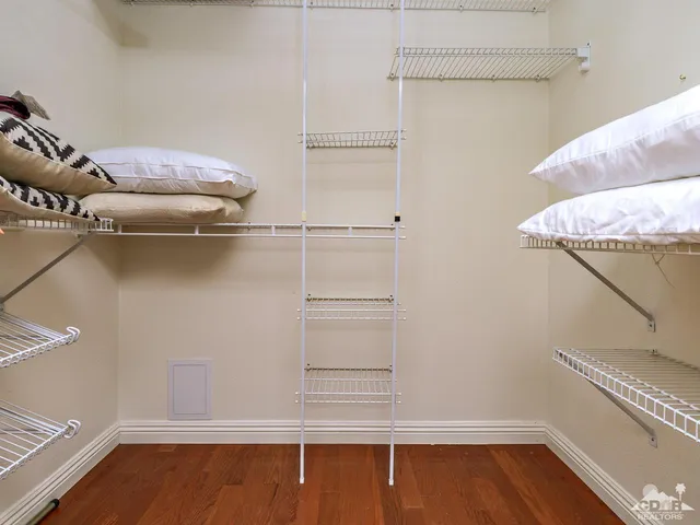 a view of walk in closet with empty racks