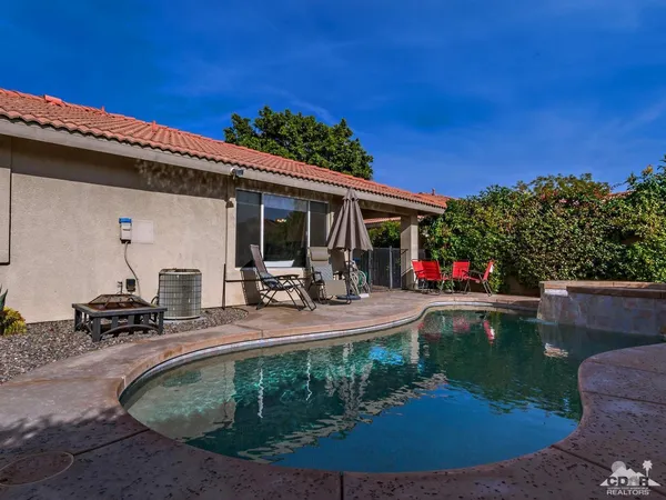 a view of a swimming pool with chairs