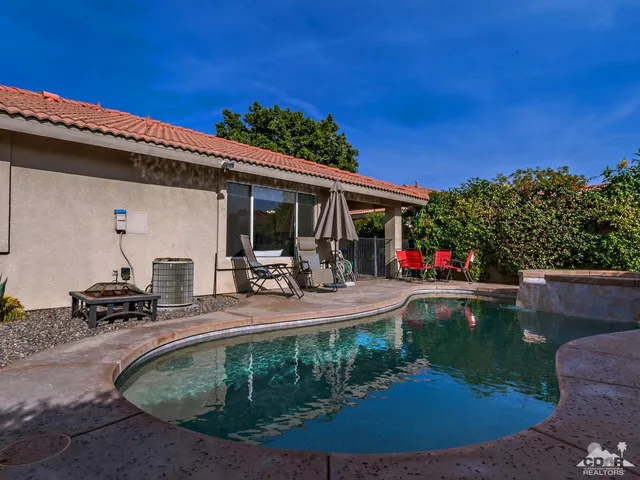 a view of a swimming pool with chairs