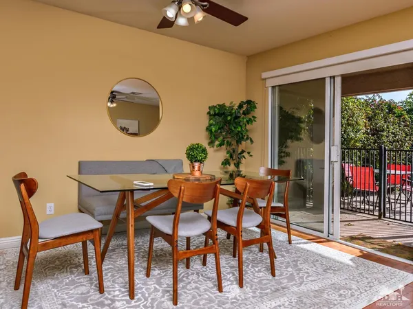 a dining room with furniture and window
