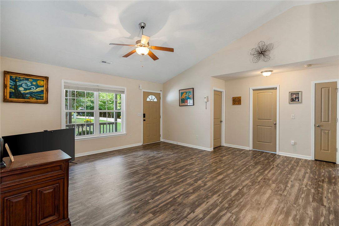 167 Mediterranean Avenue Anderson, SC 29621 - Photo 9 of 33 The open-concept living space boasts high vaulted ceilings and durable wood-look flooring.