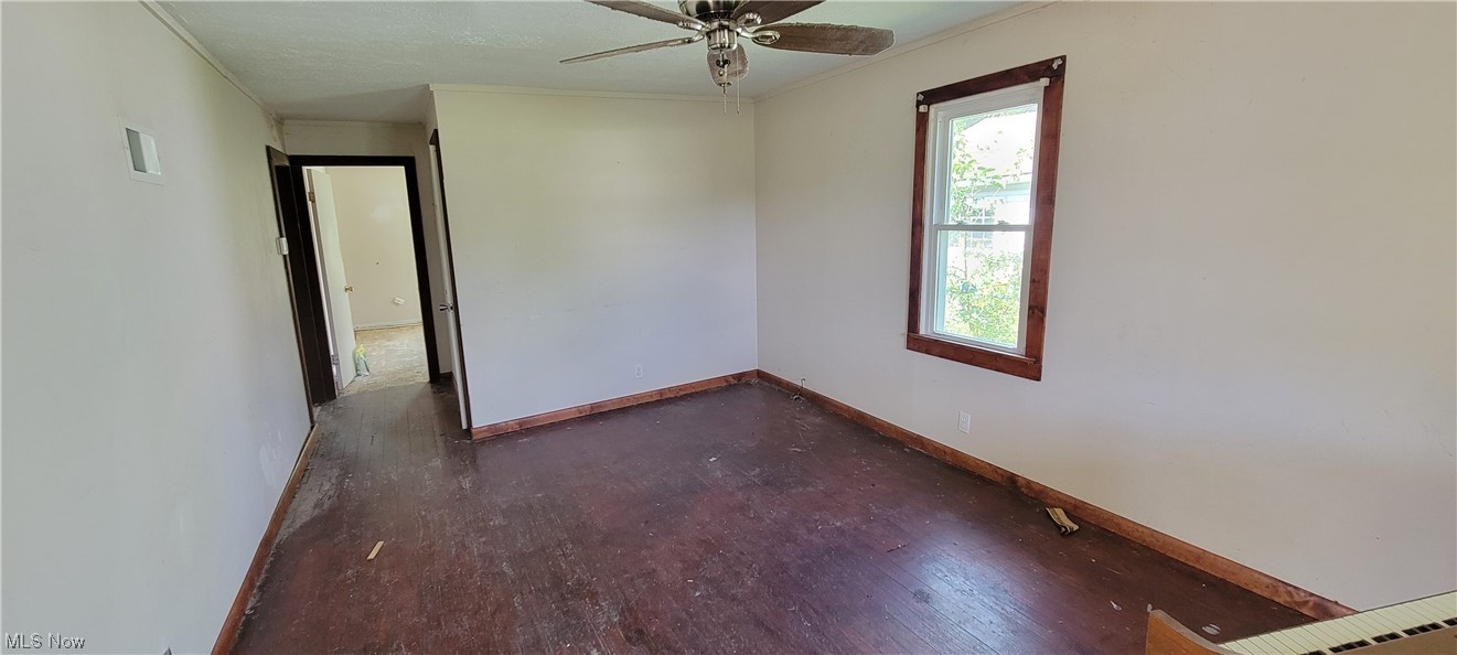 3936 Dunton Road Lorain, OH 44055 - Photo 9 of 35 Spare room with ceiling fan and dark hardwood flooring