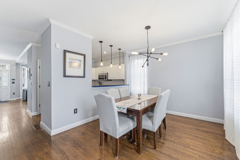 6 Millmont Street, Unit 6 Boston, MA 02119 - Photo 13 of 42 a view of a dining room with furniture window and wooden floor