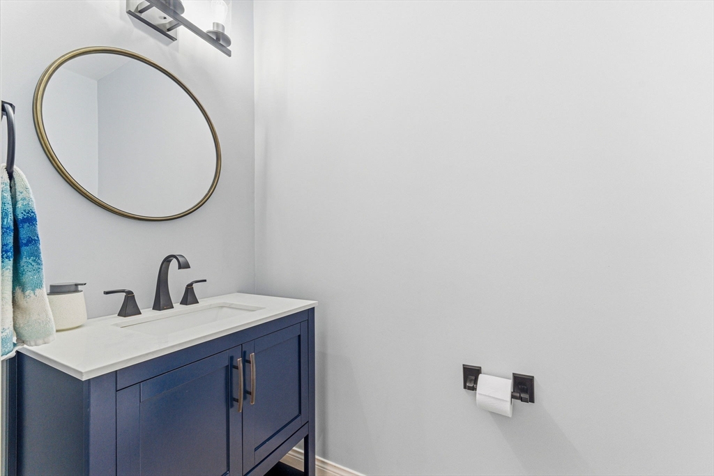 6 Millmont Street, Unit 6 Boston, MA 02119 - Photo 18 of 42 a bathroom with a sink and a mirror