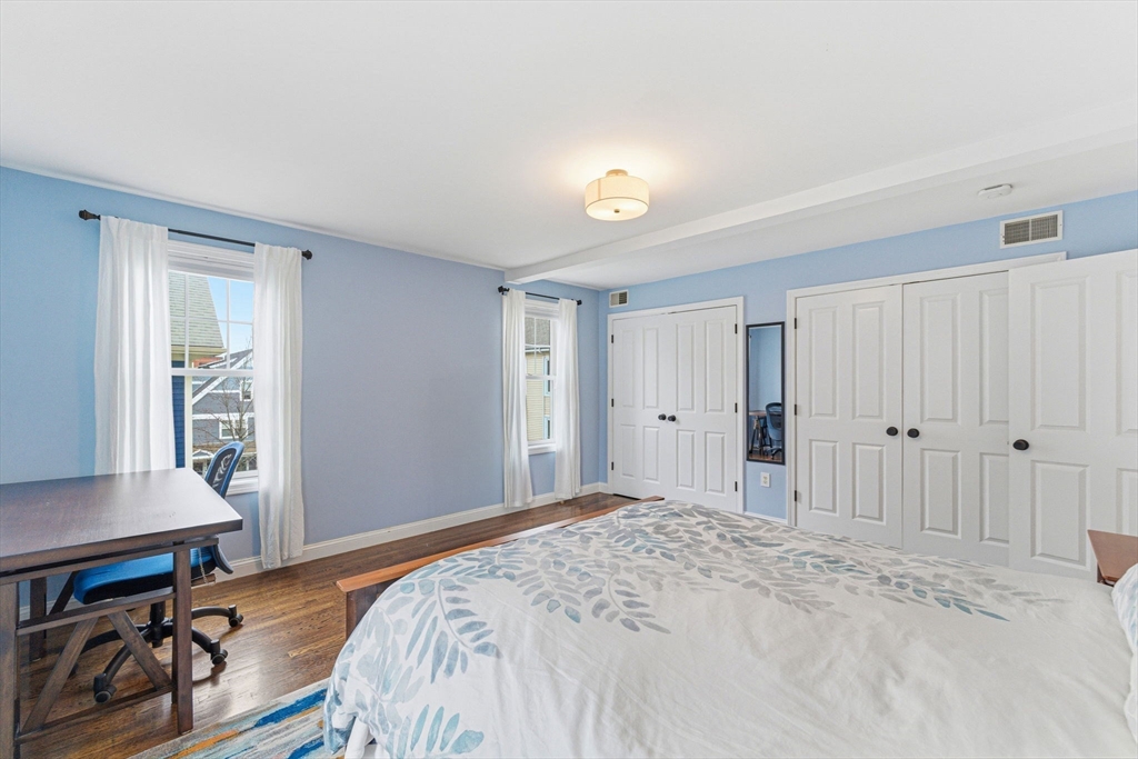 6 Millmont Street, Unit 6 Boston, MA 02119 - Photo 20 of 42 a bedroom with a bed and a chair