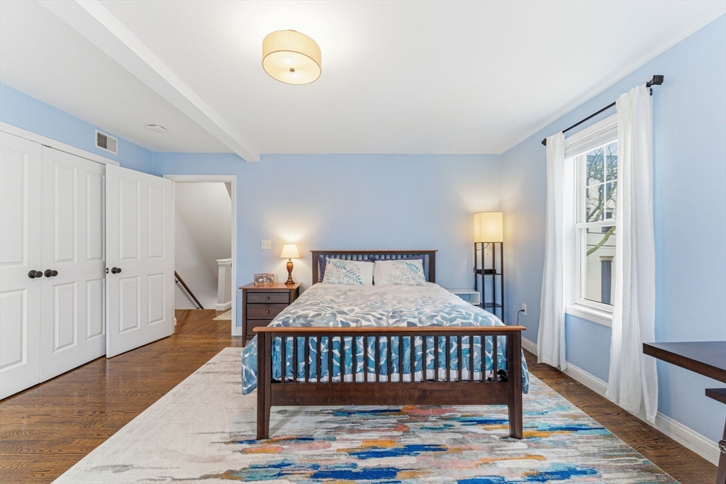 6 Millmont Street, Unit 6 Boston, MA 02119 - Photo 21 of 42 a bedroom with a bed and window