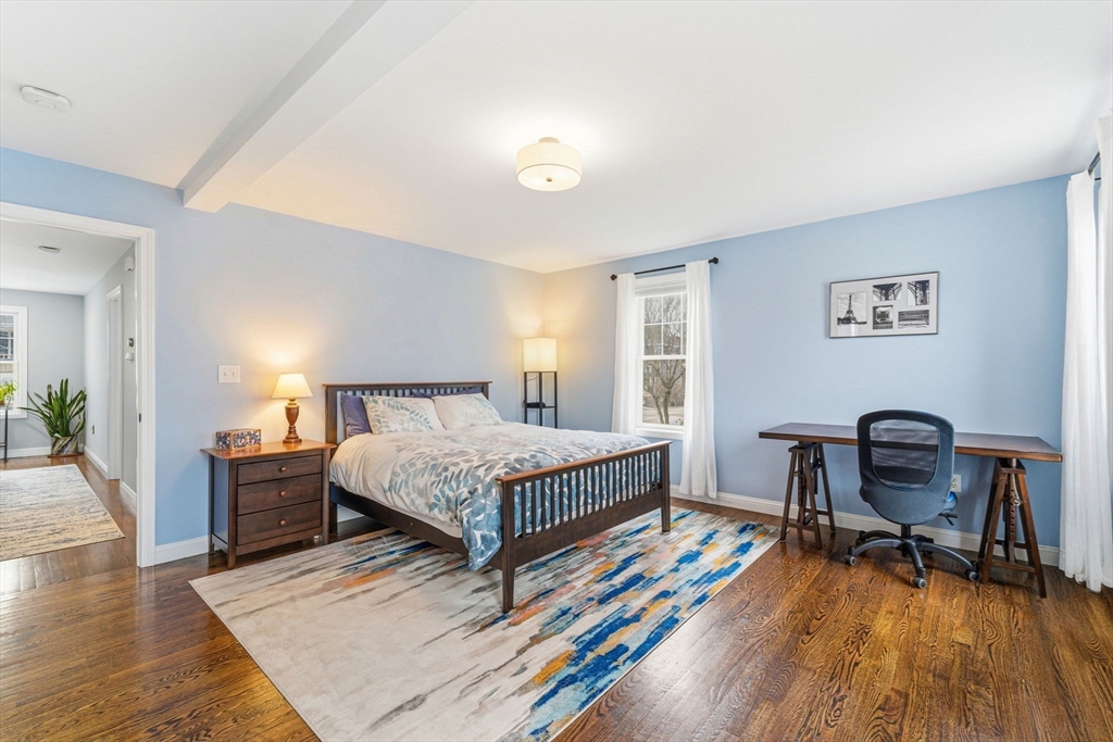 6 Millmont Street, Unit 6 Boston, MA 02119 - Photo 22 of 42 a bedroom with a bed and a desk