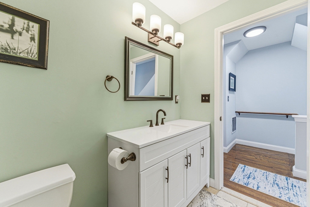 6 Millmont Street, Unit 6 Boston, MA 02119 - Photo 25 of 42 a bathroom with a sink a toilet and mirror