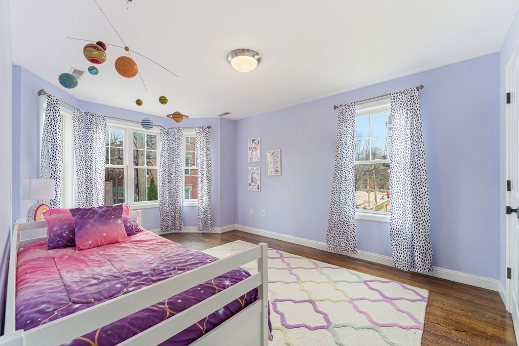 6 Millmont Street, Unit 6 Boston, MA 02119 - Photo 26 of 42 a bedroom with a bed and a window