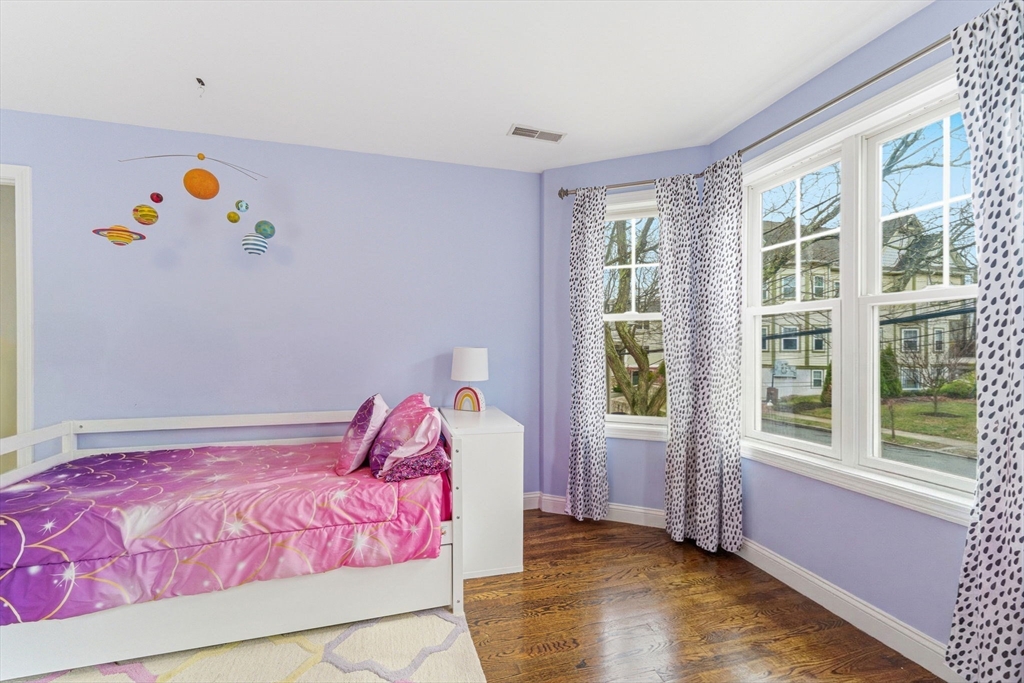 6 Millmont Street, Unit 6 Boston, MA 02119 - Photo 27 of 42 a bedroom with a bed and a window