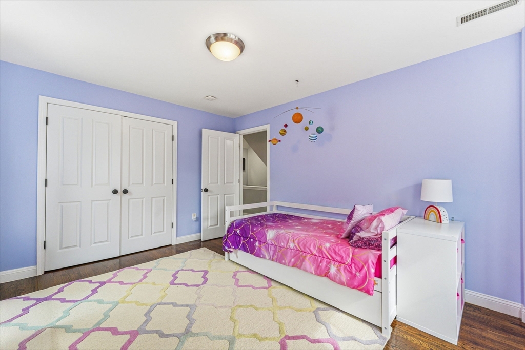 6 Millmont Street, Unit 6 Boston, MA 02119 - Photo 28 of 42 a bedroom with a bed and a window
