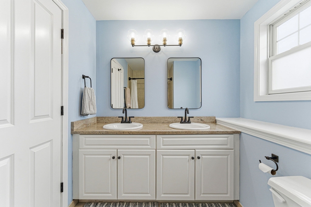 6 Millmont Street, Unit 6 Boston, MA 02119 - Photo 30 of 42 a bathroom with double vanity sinks and a mirror