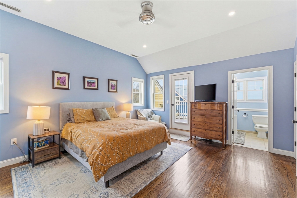 6 Millmont Street, Unit 6 Boston, MA 02119 - Photo 33 of 42 a bedroom with a large bed and a flat tv screen