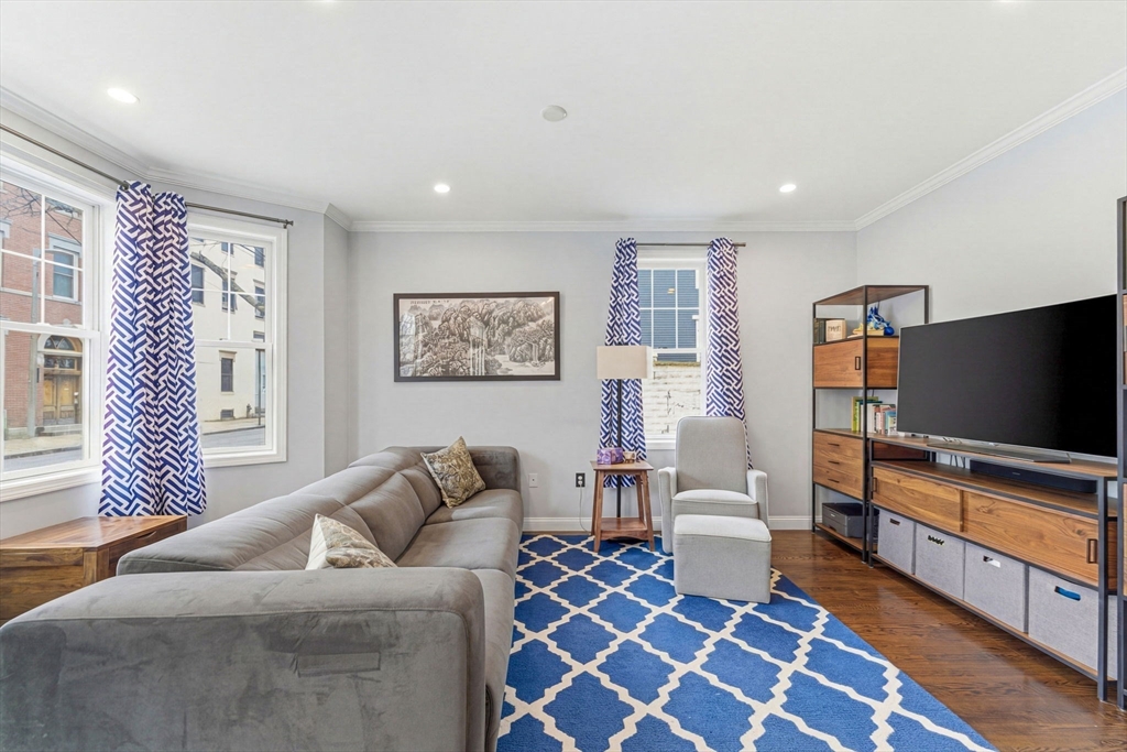6 Millmont Street, Unit 6 Boston, MA 02119 - Photo 7 of 42 a living room with furniture and a flat screen tv