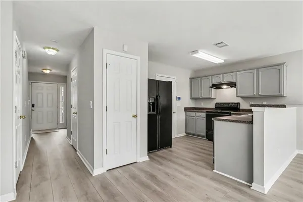a kitchen with cabinets appliances and a sink