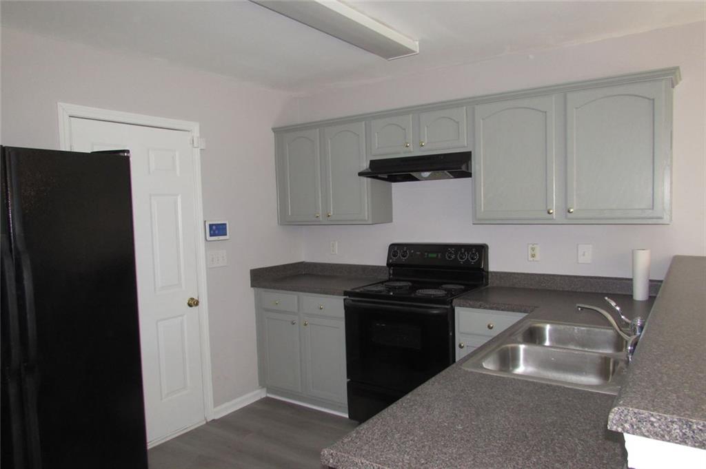 7238 April Court Morrow, GA 30260 - Photo 2 of 11 a kitchen with stainless steel appliances granite countertop a stove and a refrigerator
