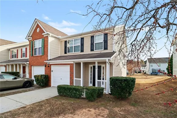 a front view of a house with a yard and garage