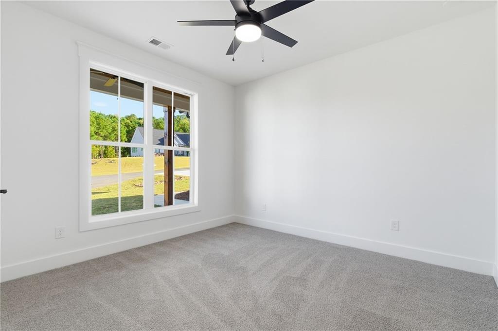 170 Field Stone Circle Jasper, GA 30143 - Photo 23 of 34 an empty room with a window and a ceiling fan