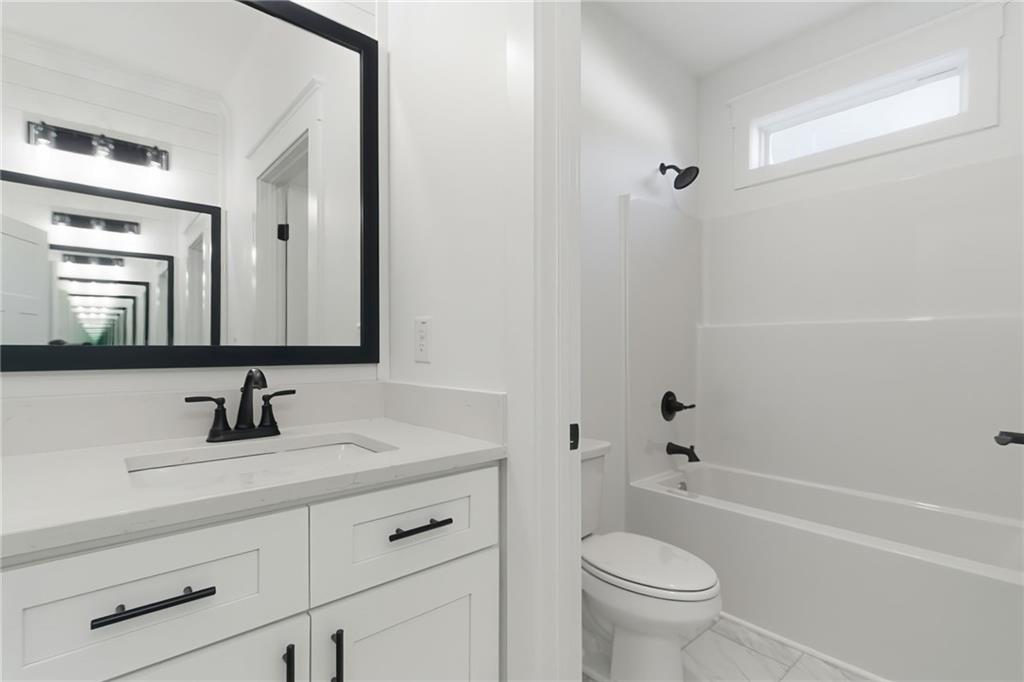 170 Field Stone Circle Jasper, GA 30143 - Photo 27 of 34 a bathroom with a sink a toilet and a mirror