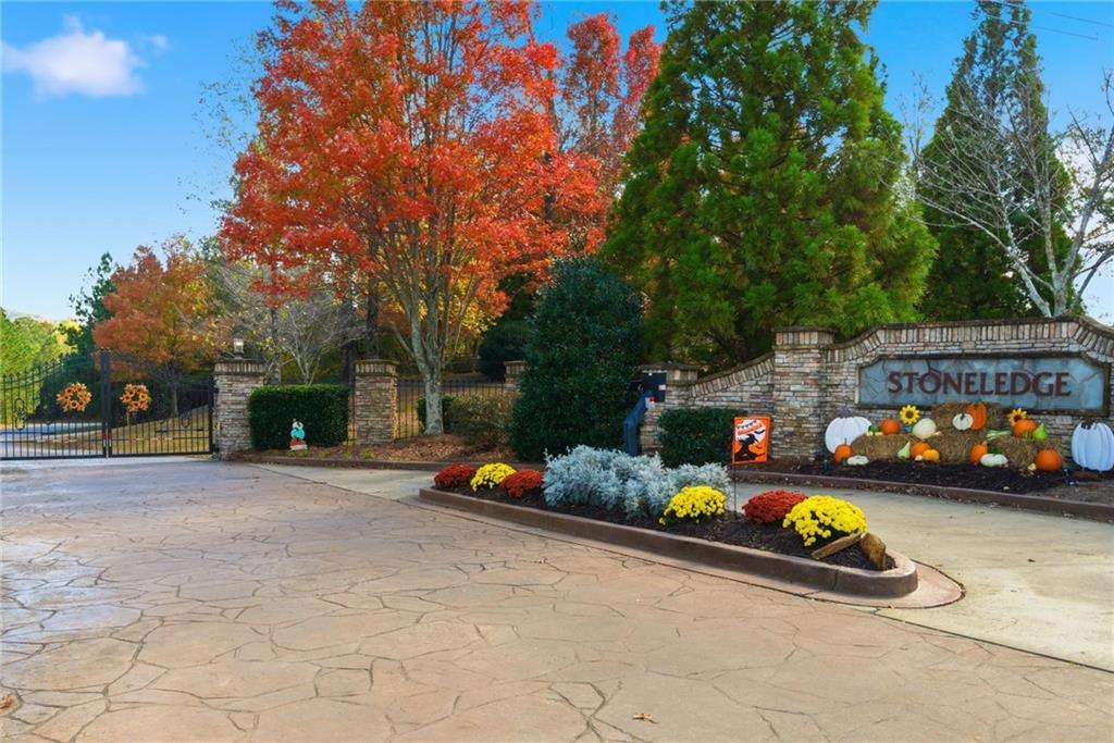 170 Field Stone Circle Jasper, GA 30143 - Photo 33 of 34 a front view of a house with a garden and cars parked