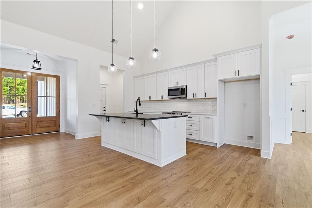 170 Field Stone Circle Jasper, GA 30143 - Photo 5 of 34 a kitchen with stainless steel appliances granite countertop a refrigerator a sink dishwasher a stove and white countertops with wooden floor