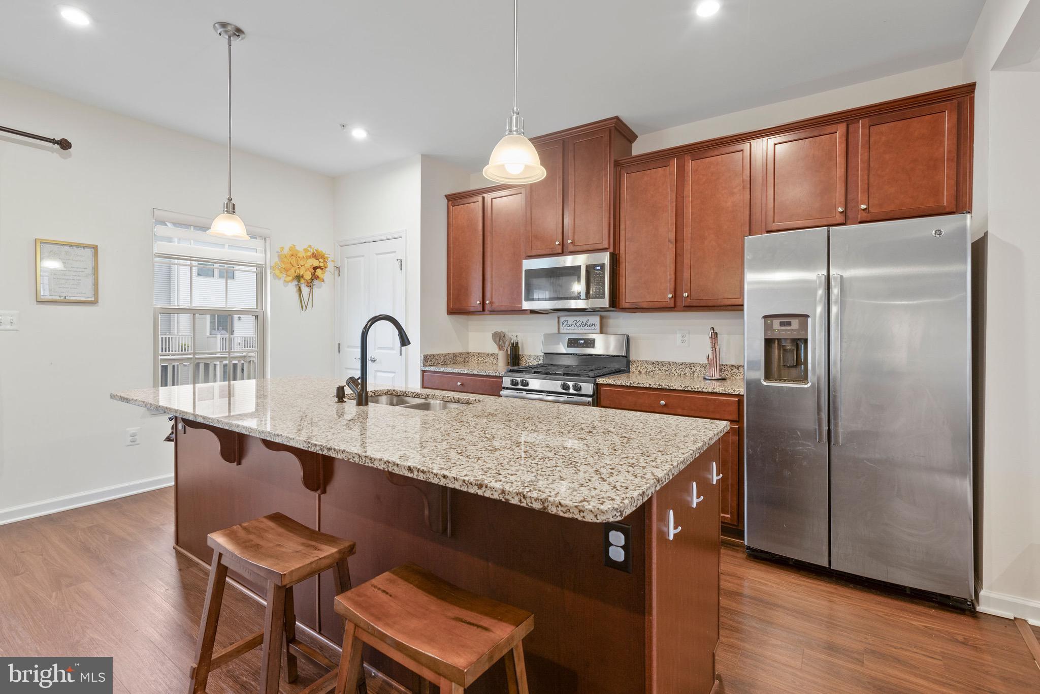 10020 Sandy Run Road Baltimore, MD 21220 - Photo 4 of 19 a kitchen with kitchen island a sink stove and refrigerator