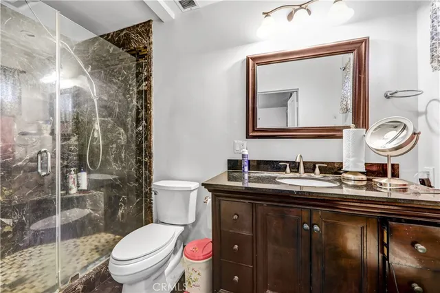 a bathroom with a toilet a sink and mirror
