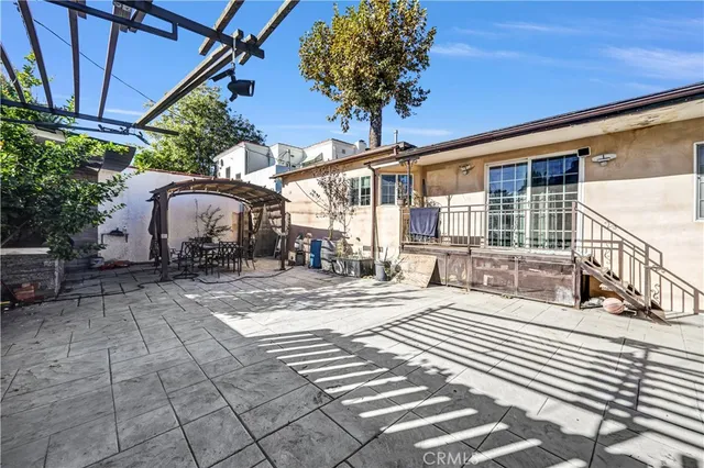 a view of a house with backyard and sitting area