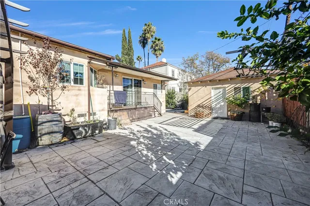 a view of a house with backyard and sitting area