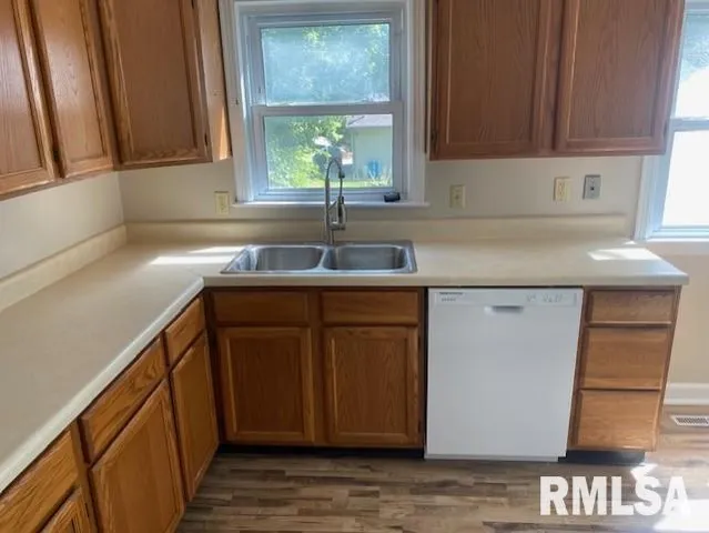 a kitchen with a refrigerator and a stove top oven
