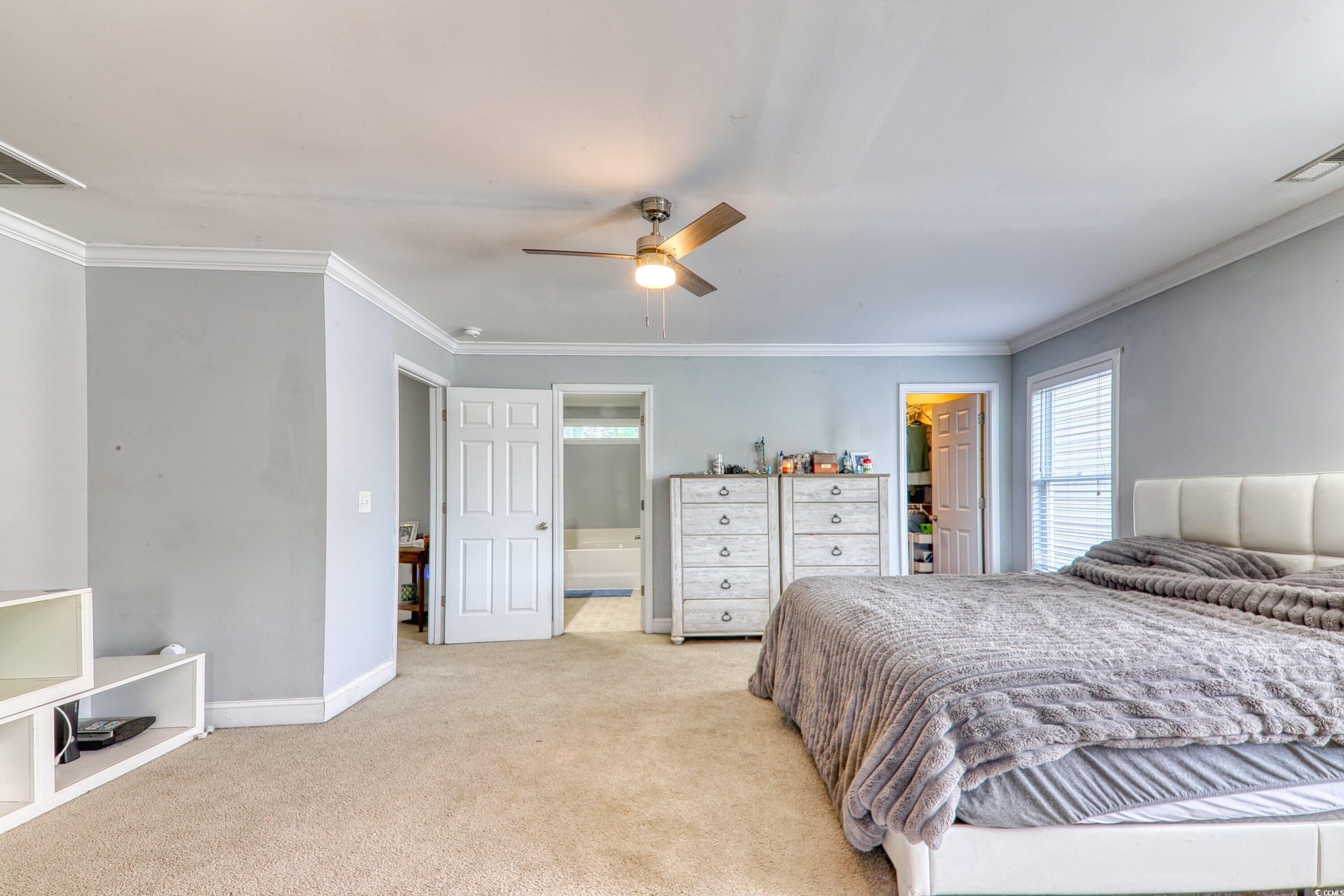 190 Hamilton Way Conway, SC 29526 - Photo 14 of 35 Bedroom with visible vents, light carpet, a walk i