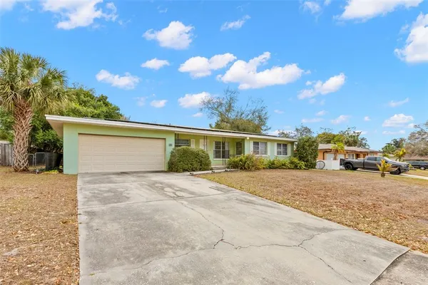 a view of a house with a yard and garage