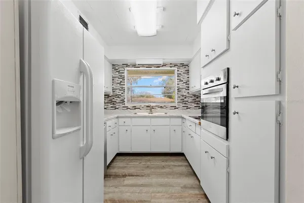 a spacious bathroom with a granite countertop sink and a mirror