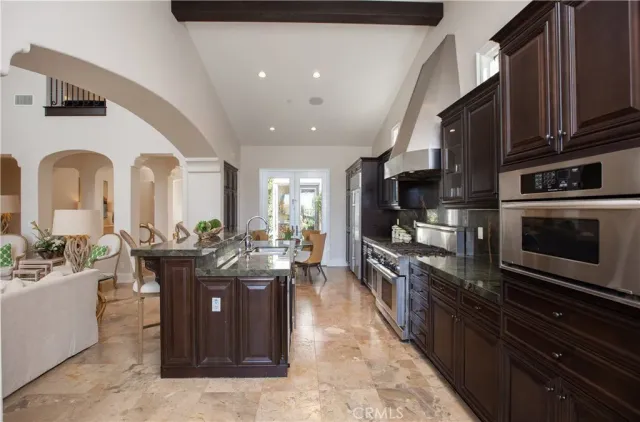 a kitchen with stainless steel appliances granite countertop a stove and a sink