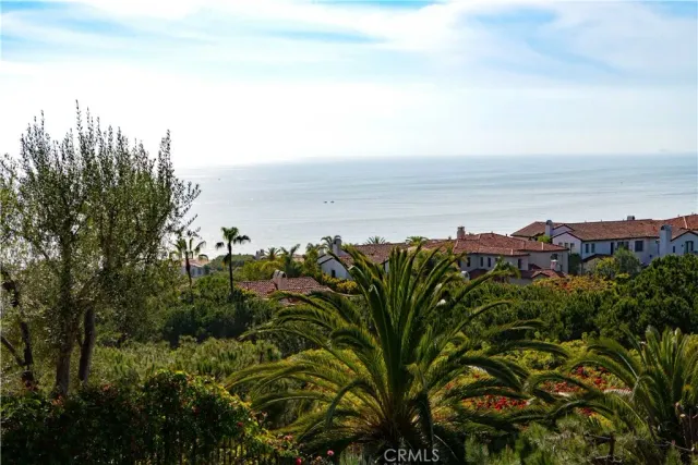 a view of a balcony with floor to ceiling window next to a yard