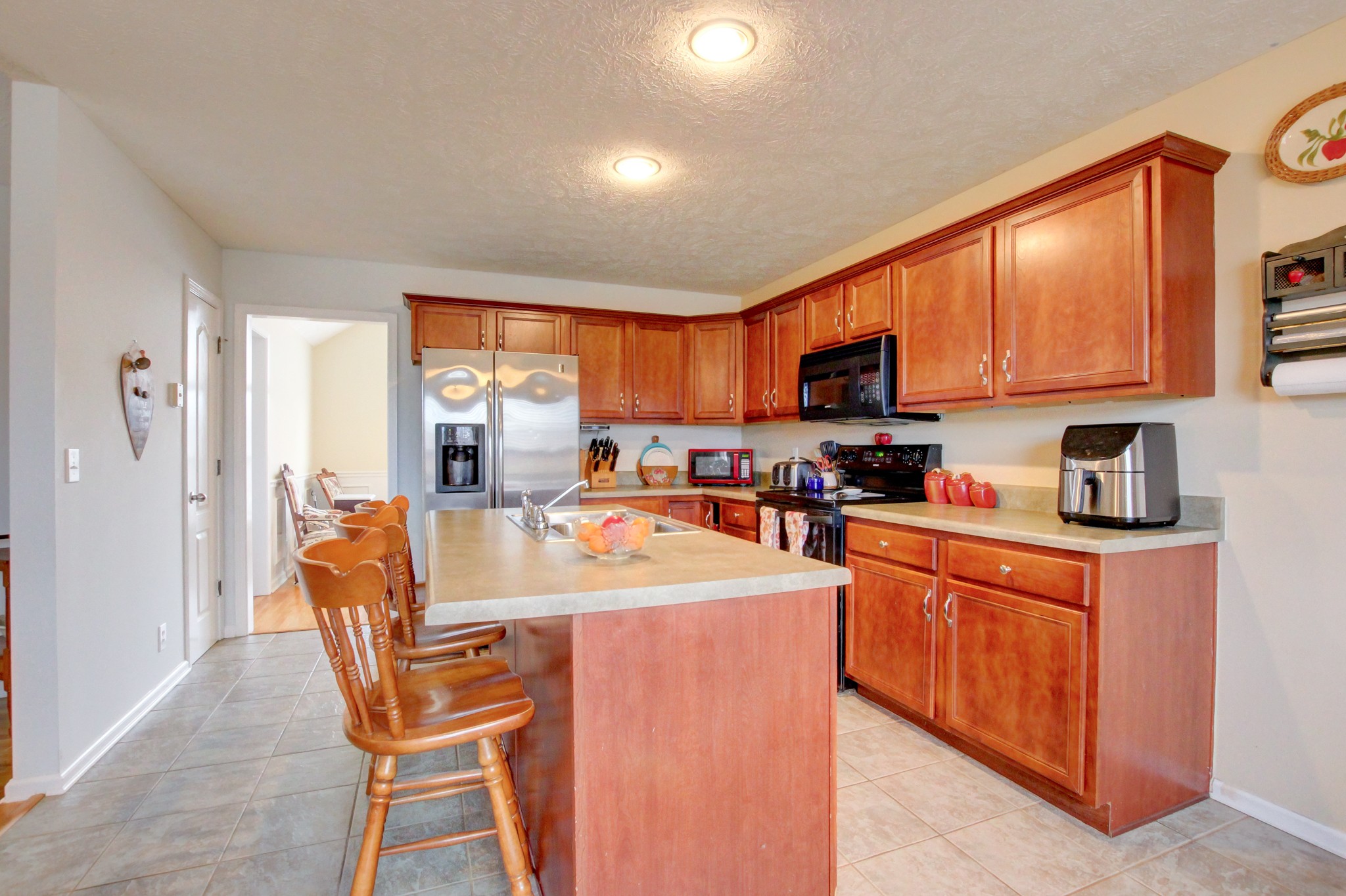 244 Cheshire Road Clarksville, TN 37043 - Photo 22 of 84 a kitchen with stainless steel appliances granite countertop a stove top oven a sink dishwasher and a refrigerator with wooden cabinets