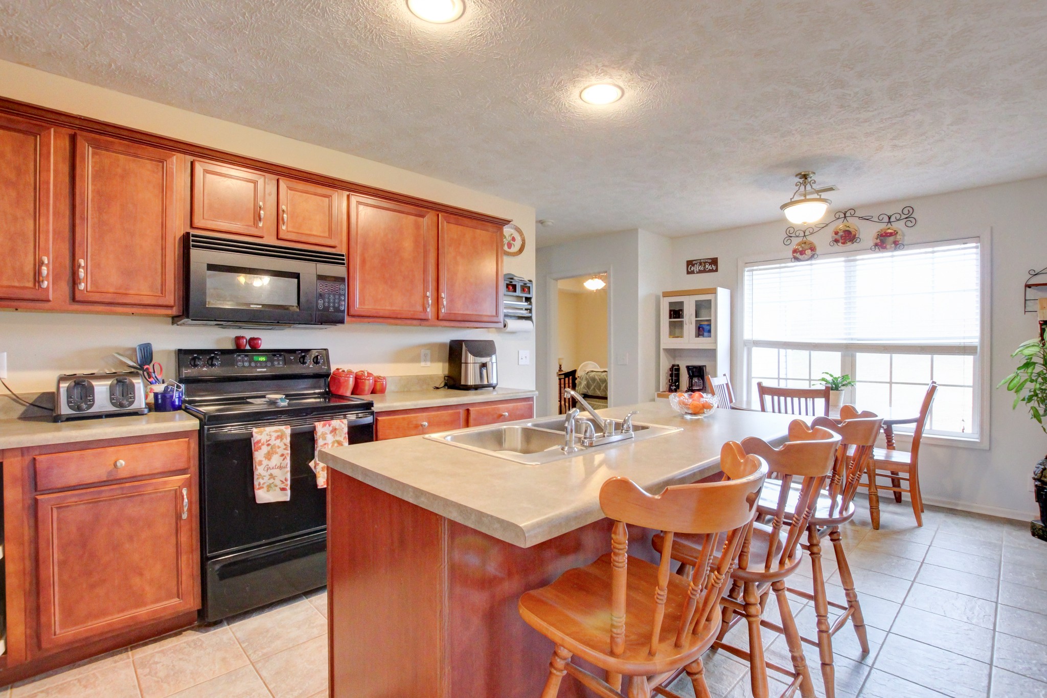 244 Cheshire Road Clarksville, TN 37043 - Photo 25 of 84 a kitchen with stainless steel appliances granite countertop a stove a sink a microwave and a refrigerator