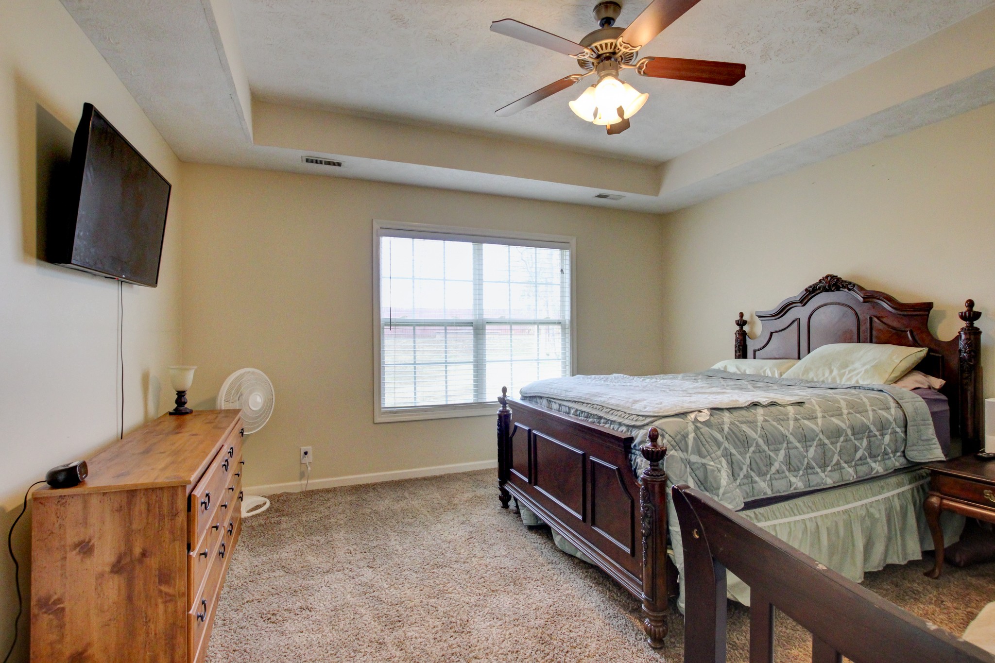 244 Cheshire Road Clarksville, TN 37043 - Photo 45 of 84 a bedroom with a bed and a flat tv screen on the dresser