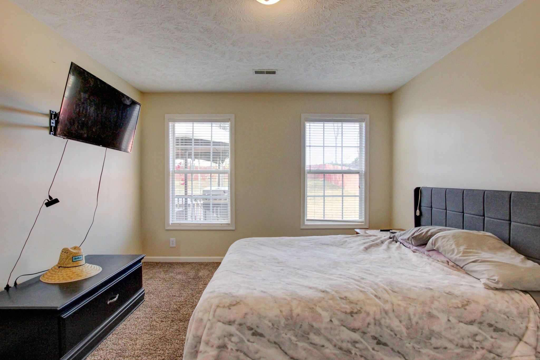 244 Cheshire Road Clarksville, TN 37043 - Photo 60 of 84 a bedroom with a bed and flat tv screen on the dresser