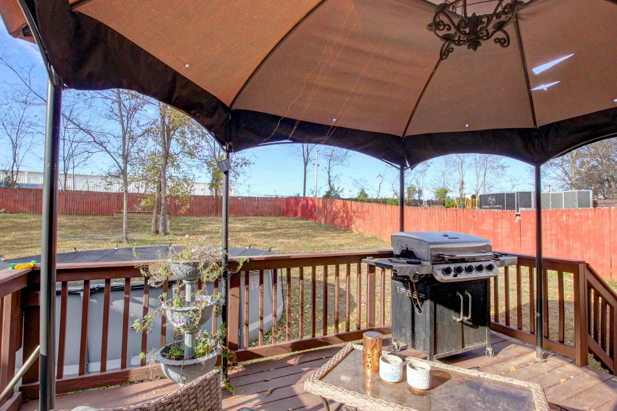 244 Cheshire Road Clarksville, TN 37043 - Photo 78 of 84 a view of a roof deck with table and chairs under an umbrella
