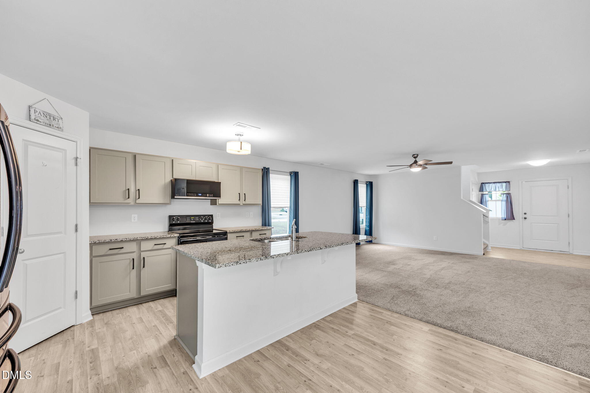177 Yellowwood Avenue Spring Hope, NC 27882 - Photo 12 of 31 a view of a kitchen with stainless steel appliances granite countertop a stove top oven a sink dishwasher and a refrigerator with wooden floor